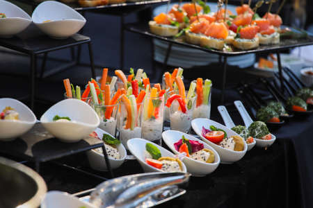 Vegetables in sauce on a buffet table, sweet paprika and carrotsの写真素材