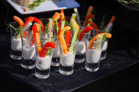 Vegetables in sauce on a buffet table, sweet paprika and carrotsの写真素材