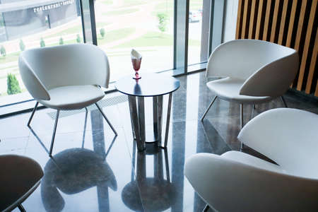 White armchairs in the interior, panoramic windows, wooden walls.の写真素材