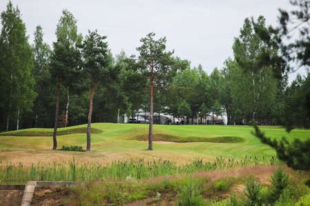 Lake surrounded by greenery on the territory of the golf club. Artificial reservoir.の写真素材