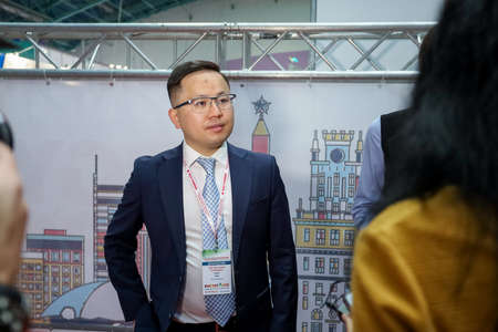 Minsk. Belarus: 12.10.2021 - Visitors walk among the exhibition stands on the Energy Expo exhibition in Minsk.のeditorial素材