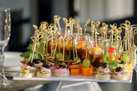 Appetizers on the white plate on a buffet table. High quality photoの写真素材