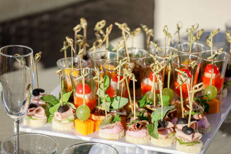 Appetizers on the white plate on a buffet table. High quality photoの写真素材
