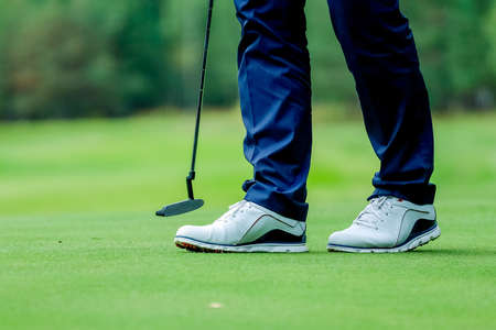 Golfer standing on field, playing golf on course tee shot address.concept strengthens the bodyの写真素材