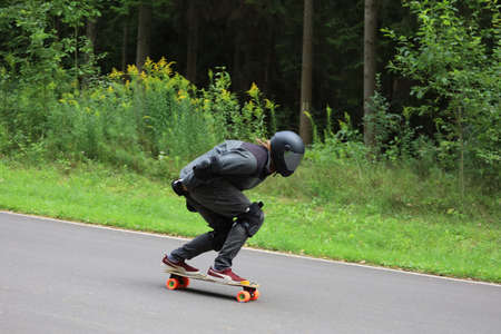 Longboard competition, athletes on the track in the middle of a forest.の写真素材