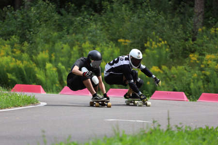 Longboard competition, athletes on the track in the middle of a forest.の写真素材