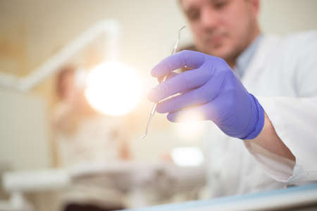 Tools in the hands of the dentist. Blue glovesの写真素材