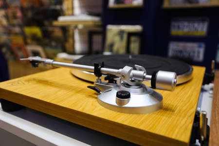 Turntable with vinyl record on wooden background, top view. High quality photoの写真素材