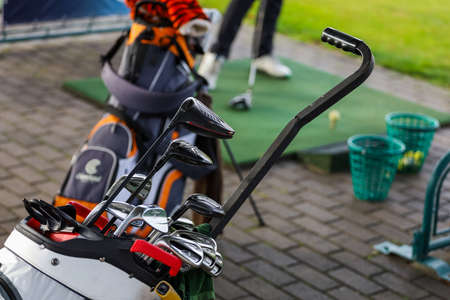 Minsk. Belarus - 16.10.2021 - Silver golf clubs in the bag on the fieldのeditorial素材