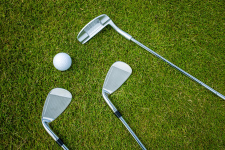 Golf clubs and ball on a green grass, backgroundの写真素材