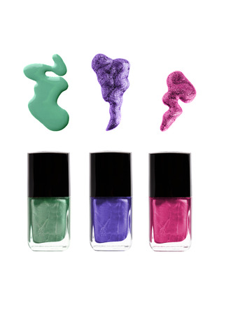 Nail polish bottles with spills  green, violet, purple or pink colorsの写真素材