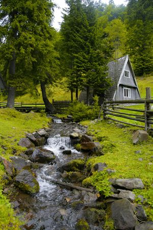The house in wood about the riverの写真素材