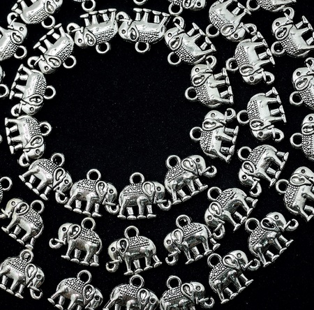 Silver material in elephant shape on black backgroundの素材
