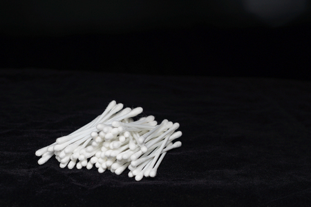 stack of white cotton bud on black backgroundの写真素材