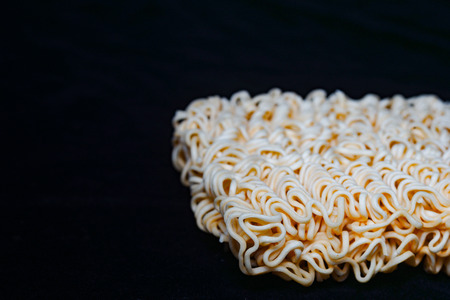 raw instant noodle on black backgroundの写真素材