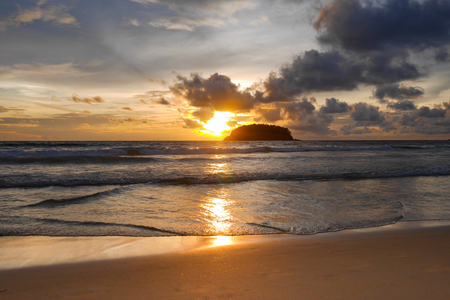 Beautiful beach at evening The sun is setting Beautiful sky Perfect for sunbathing, swimming, reading, a small island in the middle of the sea.の写真素材