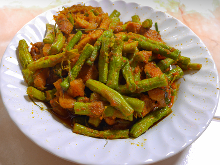 Stir Fried Bean Sprouts with hot and spicy curry , kaffir lime leaf and pork  in white plateの写真素材