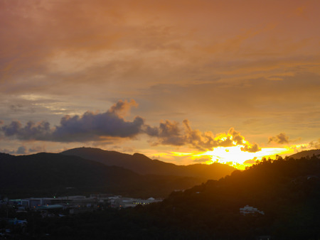 Sunset behind mountain There is a beautiful evening sunlight cloudy sky , look  from the view point on the mountain in downtown.の写真素材