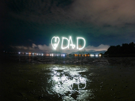 love dad text word for father 's day , made from sparkle  light paining in the dark night , motion...