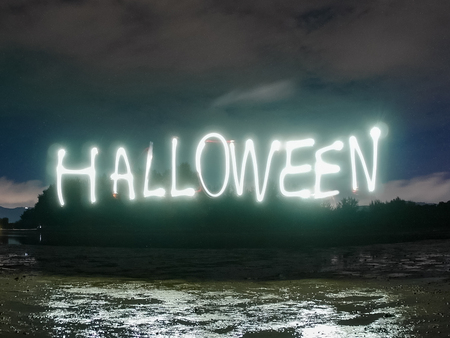 halloween text word , made from sparkle  light paining in the dark night , motion with long exposure .の写真素材