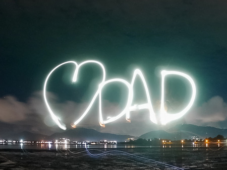 love dad text word for father 's day , made from sparkle  light paining in the dark night , motion with long exposure .の写真素材