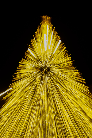 abstract, blurred background.and defocused in the dark night. and blurred christmas tree light line with long exposure motion.の写真素材