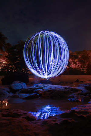 light lines of flashlight with long exposure and reflection in the water , speed motion abstract background in the dark nightの写真素材