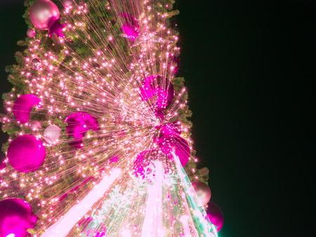 zoom burst  light blur image of  artificial pine christmas tree , bokeh of LED decorative light defocused background and textured,  for Christmas Eve , New Year party holiday and celebrationの写真素材