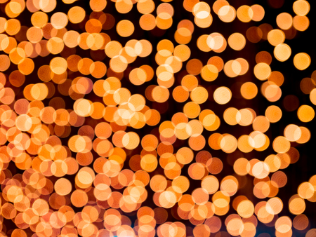 orange blurred bokeh light defocused background and textured,  for Christmas , New Year holidays and celebration backgroundの写真素材