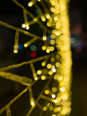 golden yellow blurred bokeh light defocused background and textured,  for Christmas , New Year holidays and celebration backgroundの写真素材