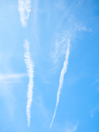 beautiful cloudy blue sky  background in the afternoon day with contrail of airplane condensation trailsの写真素材