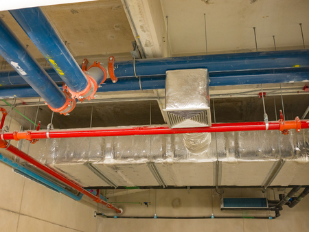 open ceiling under construction. many pipes on ceiling  sush as sewer pipe, Air Conditioning Pipes,...