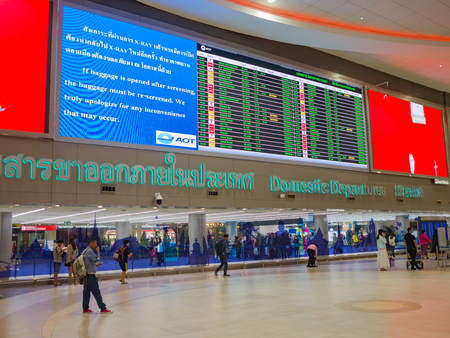 Bangkok,Thailand -January 14, 2018- Passenger are walking to the domestic departure entrance for boarding gate. Big flight  schedules timetable shown on the wallのeditorial素材