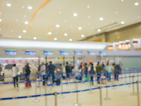blur image of passenger and tourist  were queuing for check-in at the airline counter in departure...