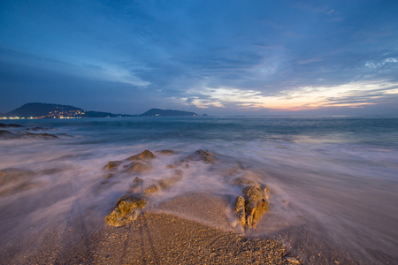 Beautiful sand beach with soft wave hit the rock and sand sea beach in the evening sunset time colorful sky.の写真素材