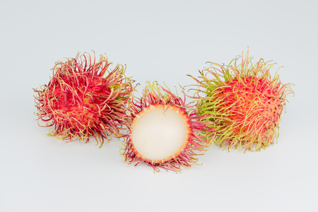peel rambutan , red hairy skin fruit sweet and delicious thai famous tropical fruit on white backgroundの写真素材