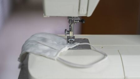 Electric sewing machine with fabric and threadの写真素材