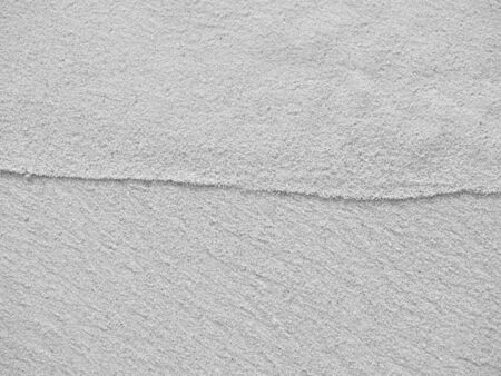 close up sand ground floor at the sea beach , background and textured, black and white color
