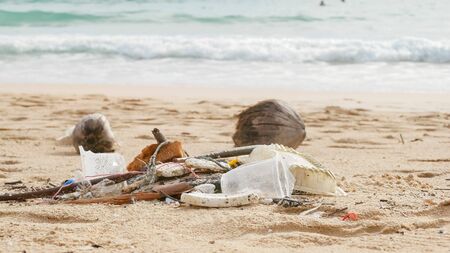 Environmental pollution. Ecological problem. Garbages, plastic, and wastes on the sandy beach of...