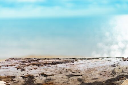 timber log on sand beach , put your product on log look like table , sea backgroundの写真素材