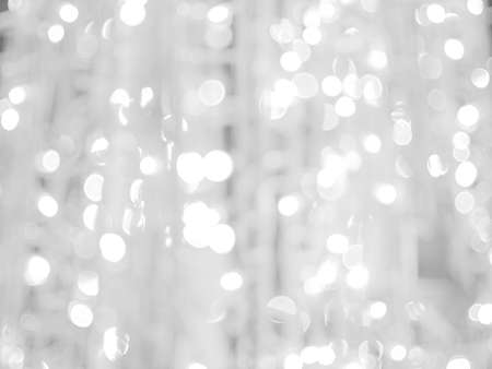 blurred bokeh light defocused background and textured for Christmas , New Year holidays party and celebration background, black and white colourの写真素材