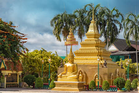 golden buddha image statue with pagoda in south of Thailandの写真素材