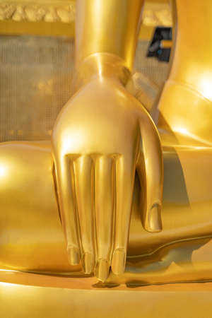 close up hand of golden buddha image statue in south of Thailandの写真素材