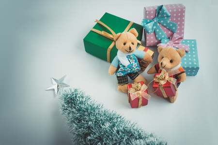 Ornament and a couple lovely teddy bear, Christmas decorate at Merry Christmas and happy new year night light. Christmas tree and other decoration with Lovely gift and ribbon .の写真素材