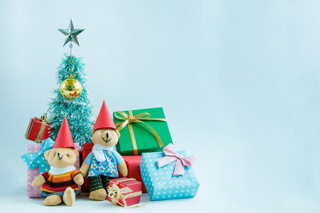 Ornament and a couple lovely teddy bear, Christmas decorate at Merry Christmas and happy new year night light. Christmas tree and other decoration with Lovely gift and ribbon .の写真素材