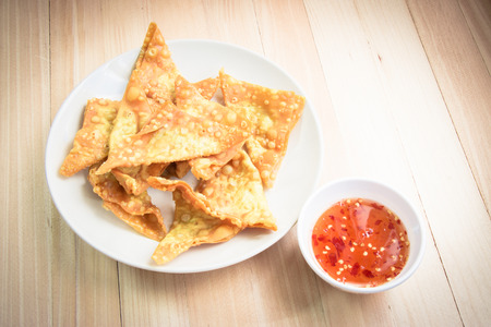 Delicious Fried dumpling crispy with spicy sauce on the wood tableの写真素材