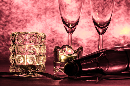 Cool Champagne and glass prepare for Celebration. Candle is lighting in a candlestick in Christmas and New year festival.の写真素材