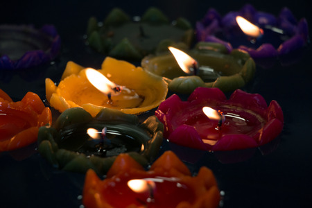 Burning flower candle on water at temple for making merit in new year festival. Pray for New Year, Lighting incense to Buddha.の写真素材