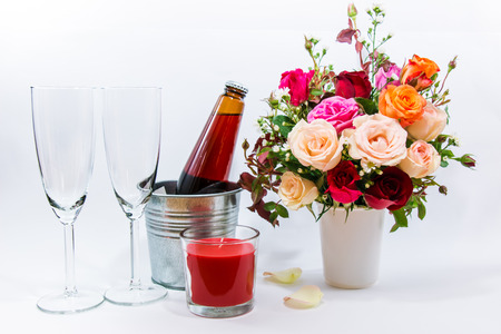Vase of Roses bouquet, candle, and champagne glass on white background, set of Beautiful flower, set of celebration Valentine conceptの写真素材