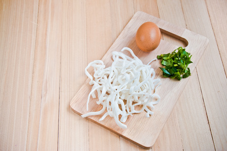 Ingredient of Pho Vietnamese noodle, original flour noodle, egg, and thai parsley put on chopping blockの写真素材